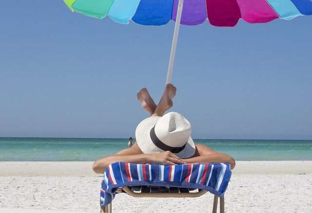 photo of a woman sunbathing on a Florida beach