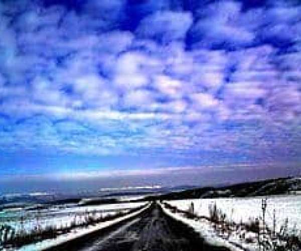 photo of a cold, snowy open road in the winter