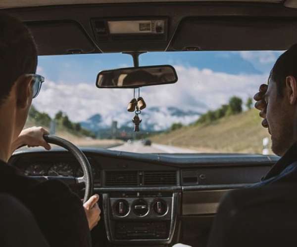 photo of friends driving across country or car shipping