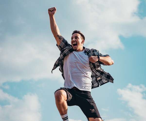 photo of young man celebrating in the air best auto transport company