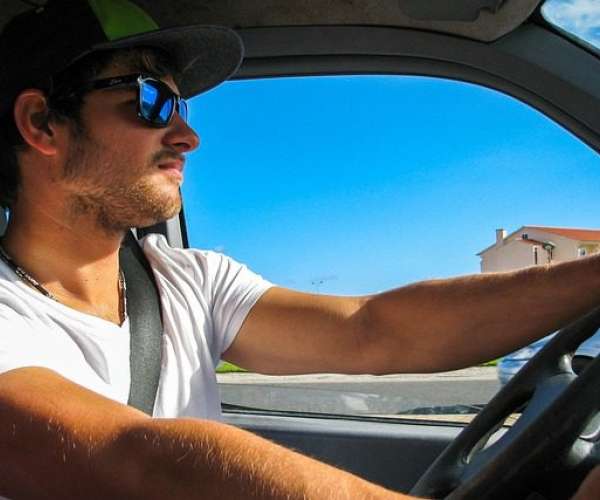 photo of young man driving and summer car shipping