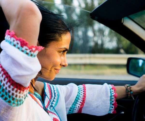 photo of a woman driving a convertible car