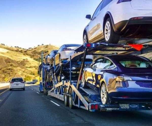 An Open-Air Car Transporter On The Road