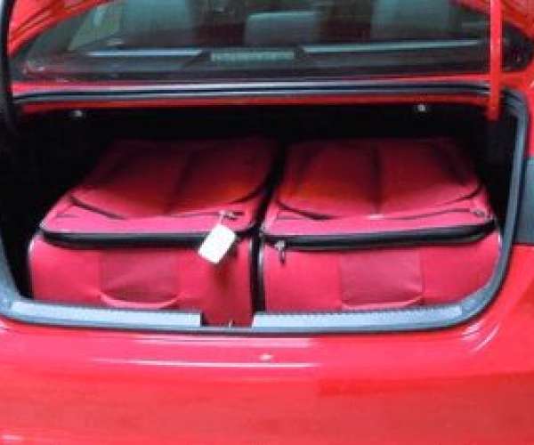 photo of suitcases in trunk of car being shipped