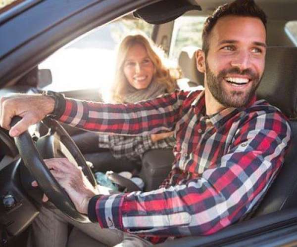 Is shipping a car a good idea? A young couple in their car.